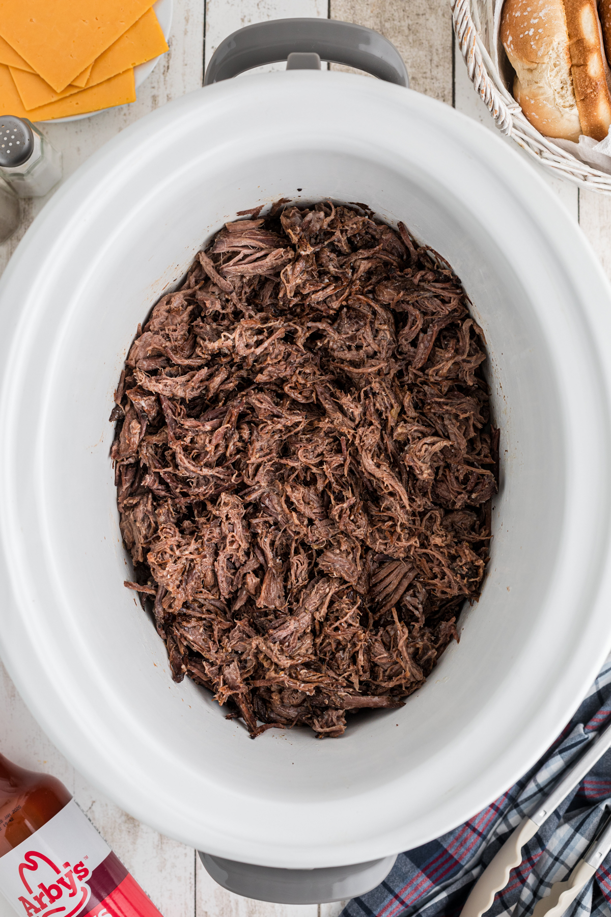 shredded meat in a crockpot for slow cooker arby's beef and cheddars.