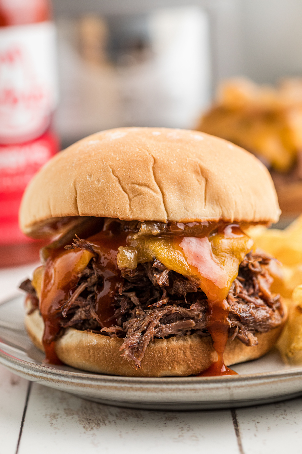 close-up of slow cooker arby's beef and cheddar sandwich on a plate.