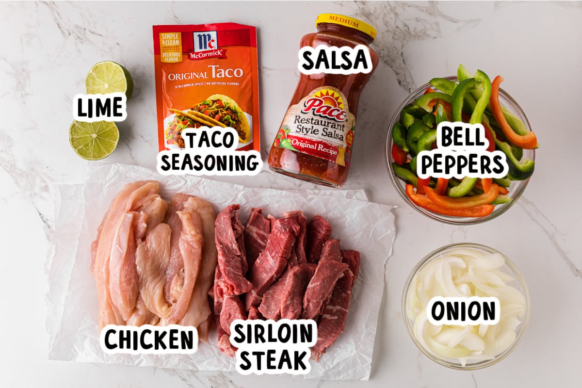 Ingredients for chicken and steak fajitas on a table.