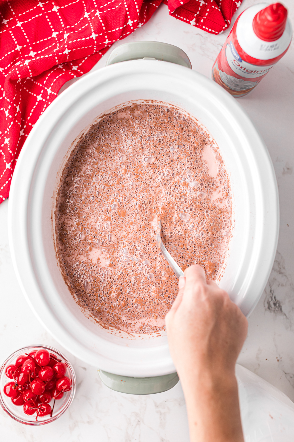 Stirring ingredients for hot chocolate after adding milk.