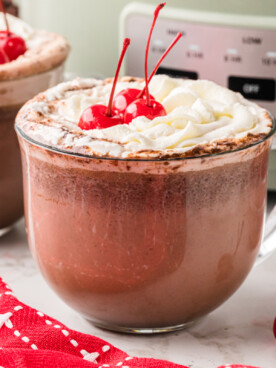 Close-up of mugs of slow cooker chocolate covered cherry hot chocolate.