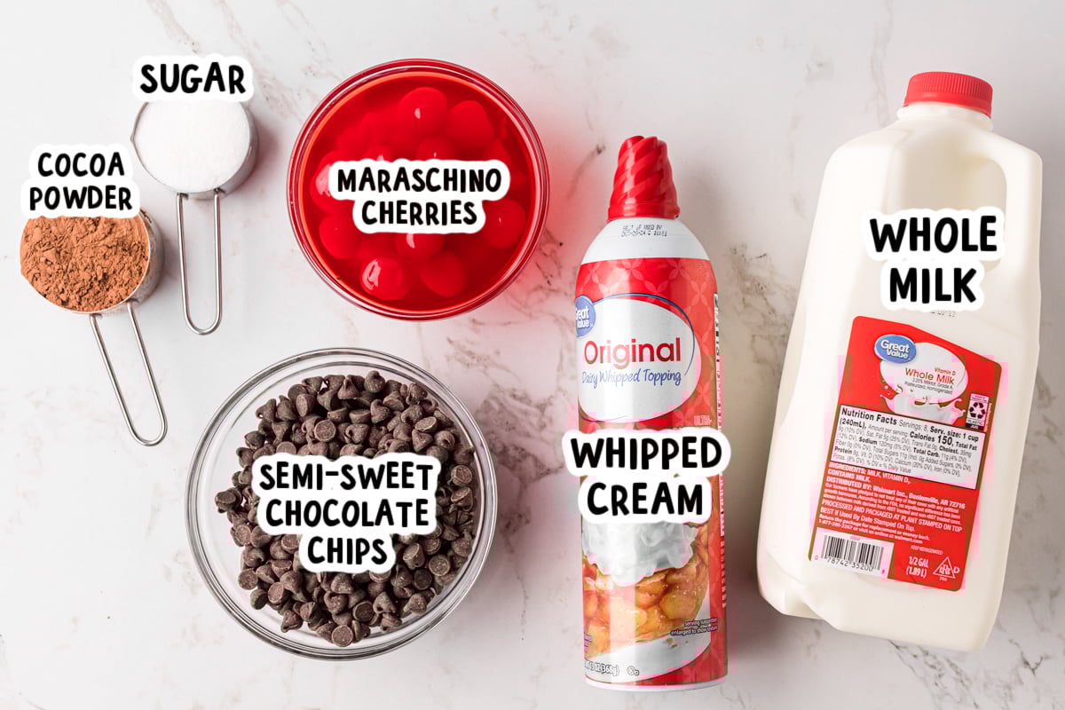 Ingredients for slow cooker chocolate covered cherry hot chocolate on a table.