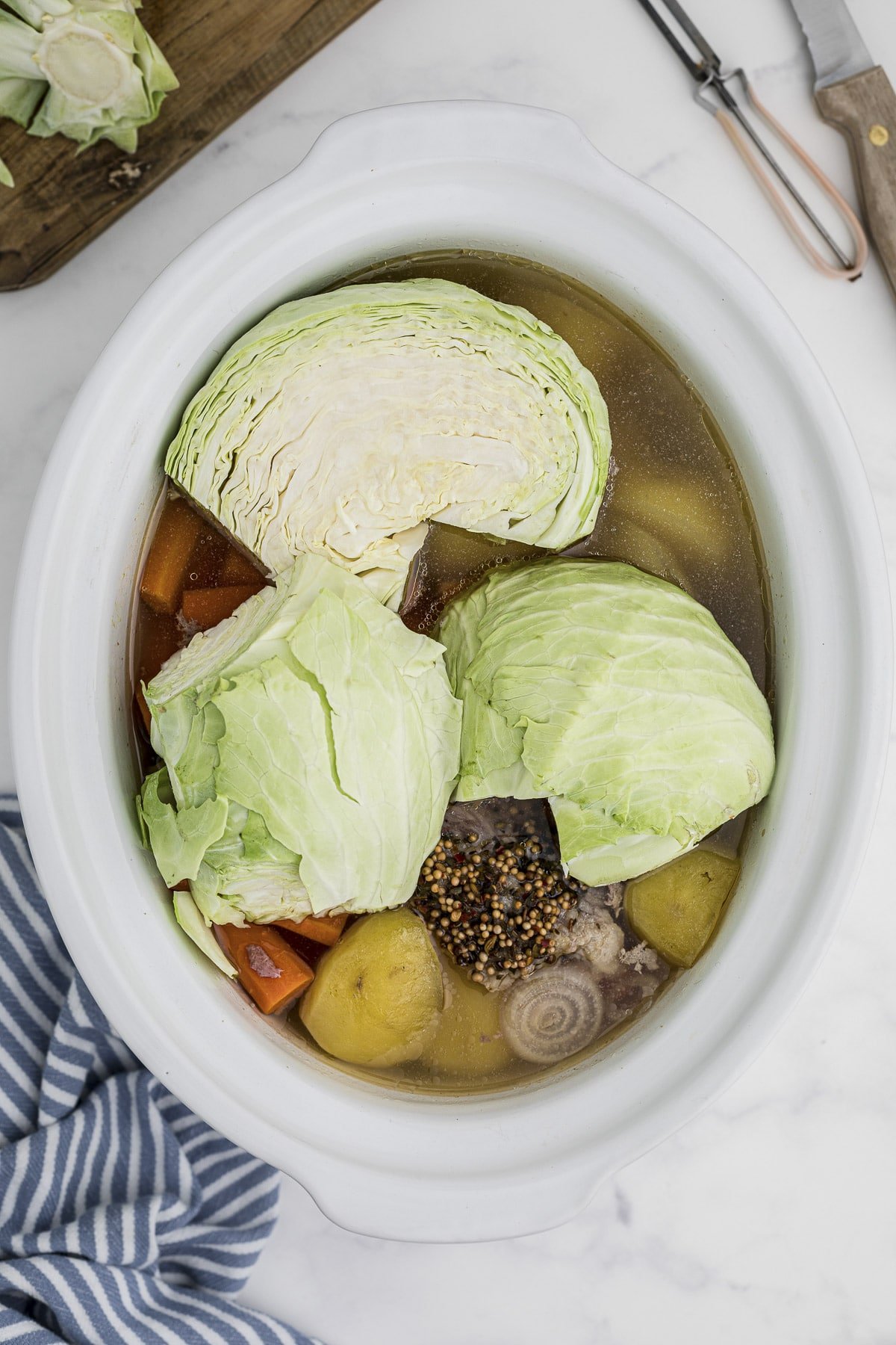 cabbage added on top of partial cooked corned beef.