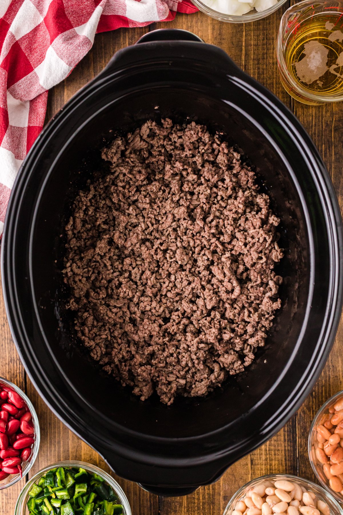 Browned ground beef in a crockpot.