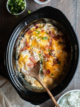 shredded creamy chicken with bacon and cheese on top.