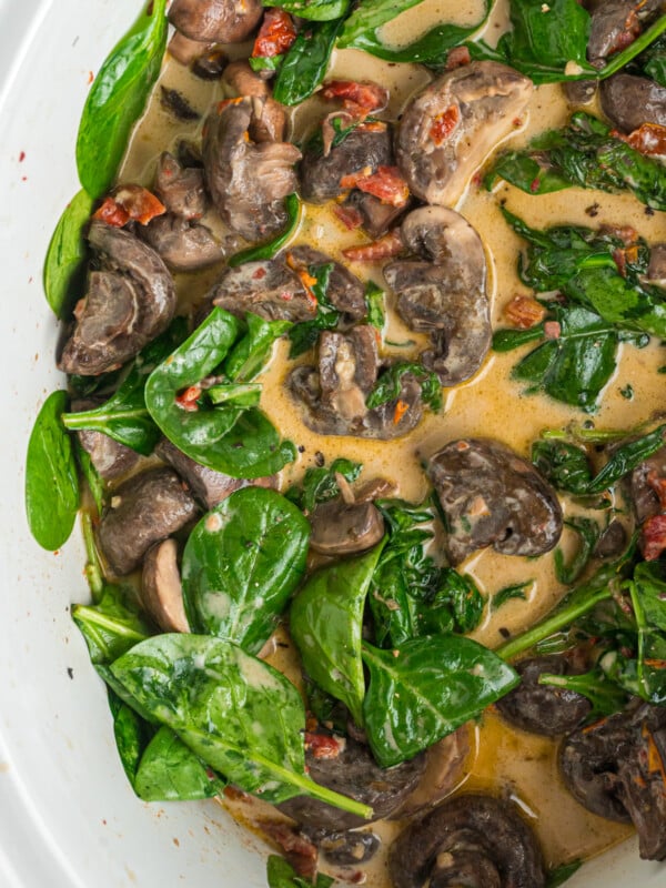close-up overhead of creamy tuscan mushrooms in crockpot.