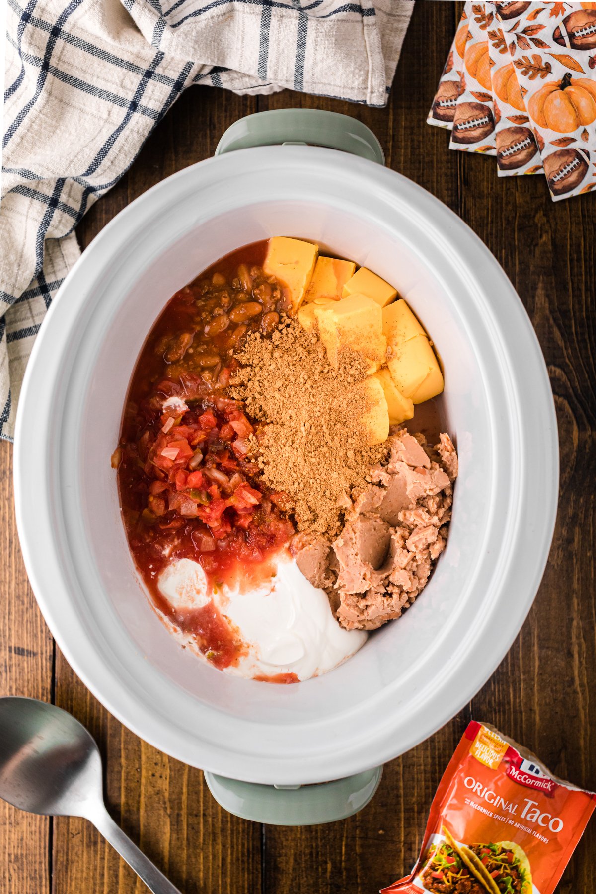 Ingredients for football dip in a crockpot before mixing.