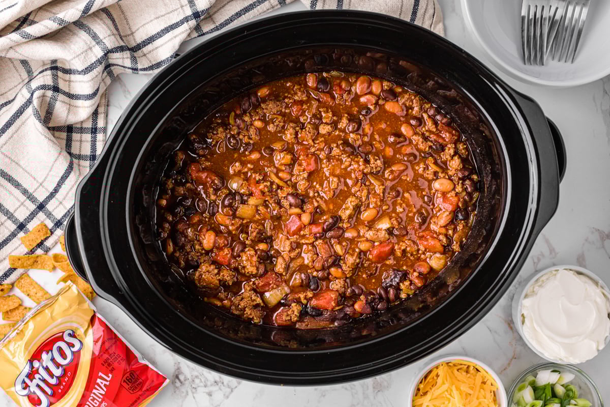 overhead shot of frito pie cooking in a crockpot.