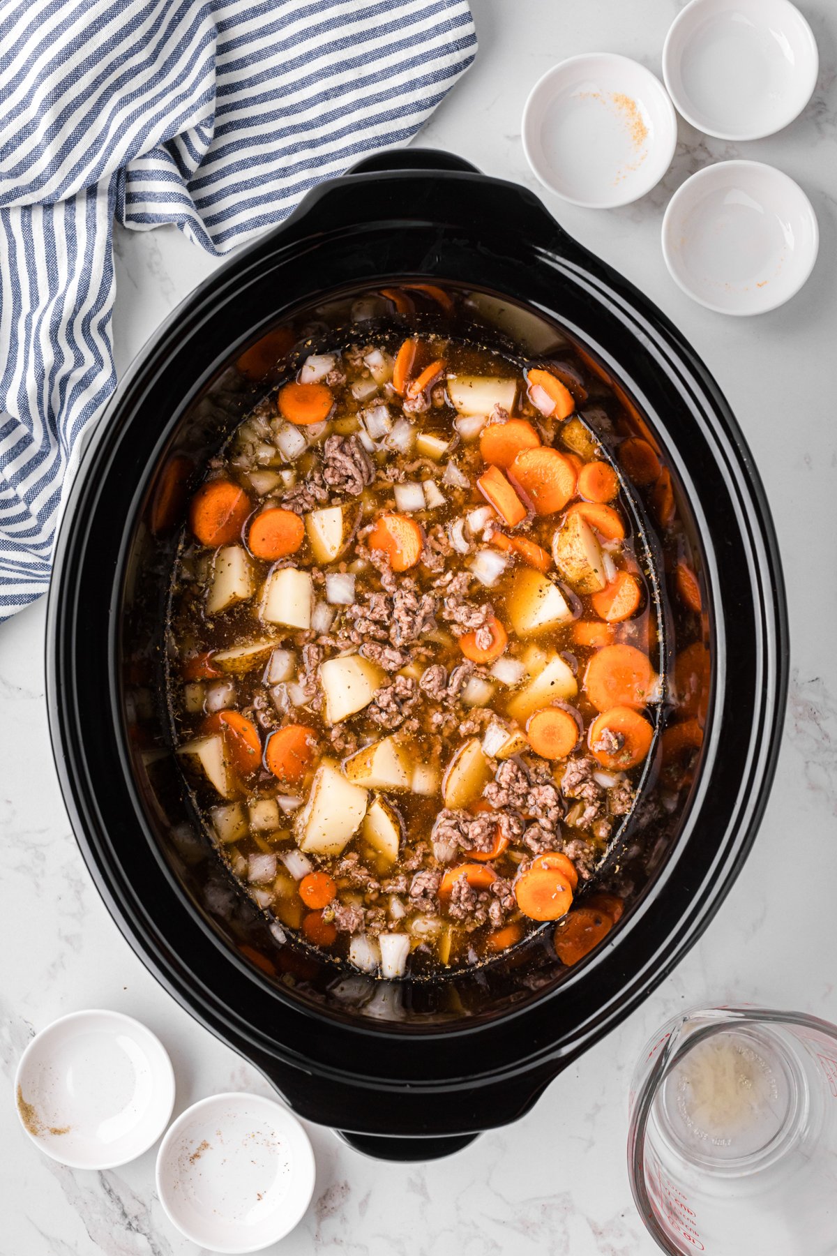 Ingredients for slow cooker hobo soup in a crockpot before cooking.