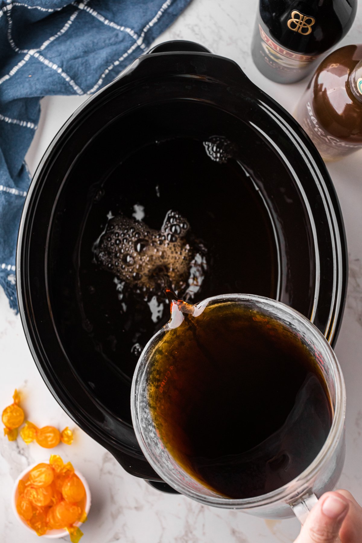 Pouring coffee into a crockpot.