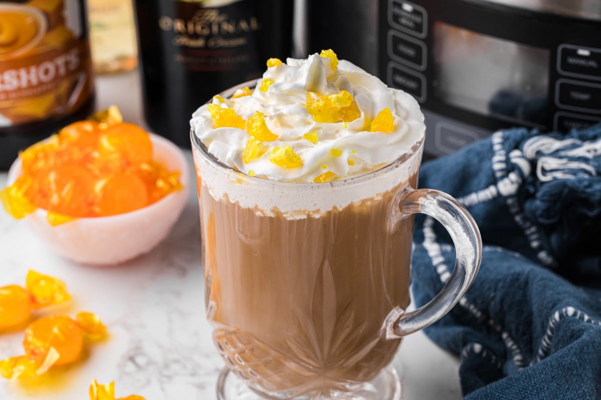 A close-up of slow cooker hot buttered rum coffee in a clear mug.