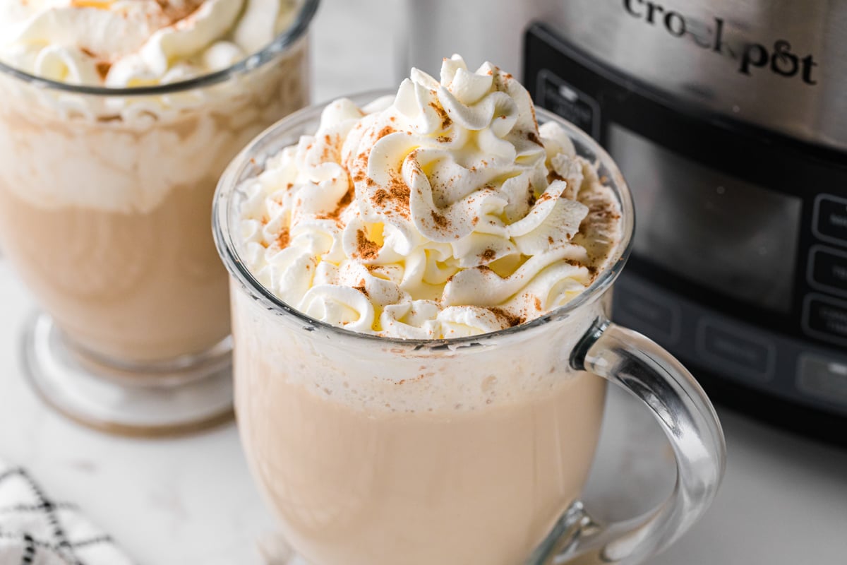 slow cooker hot white russians with whipped cream in glass mugs.