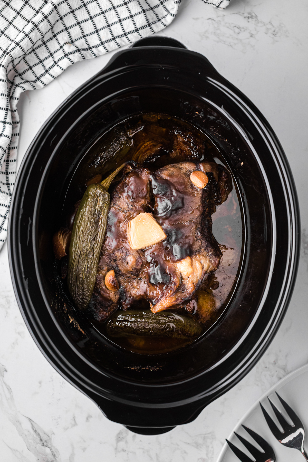 Beef and jalapenos after cooking in a crockpot.