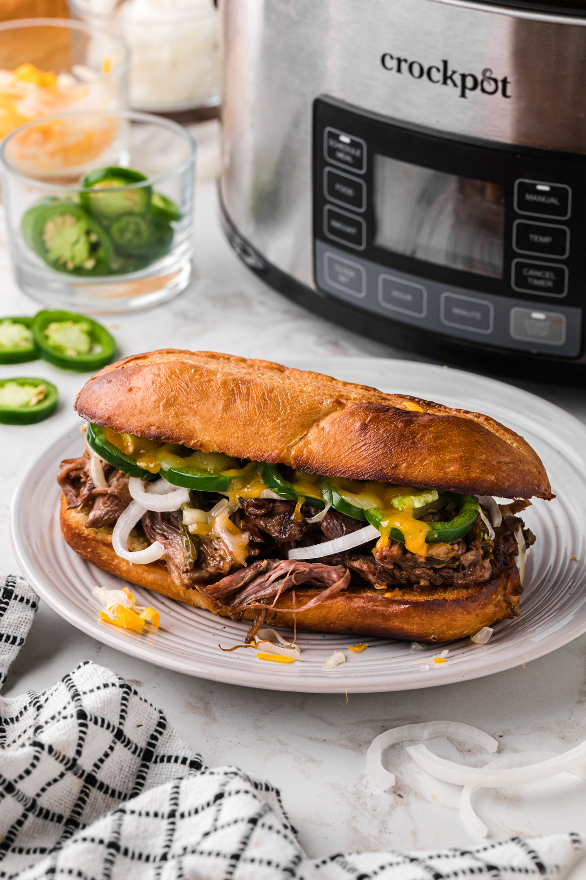 One of the slow cooker jalapeno beef sammies on a plate.