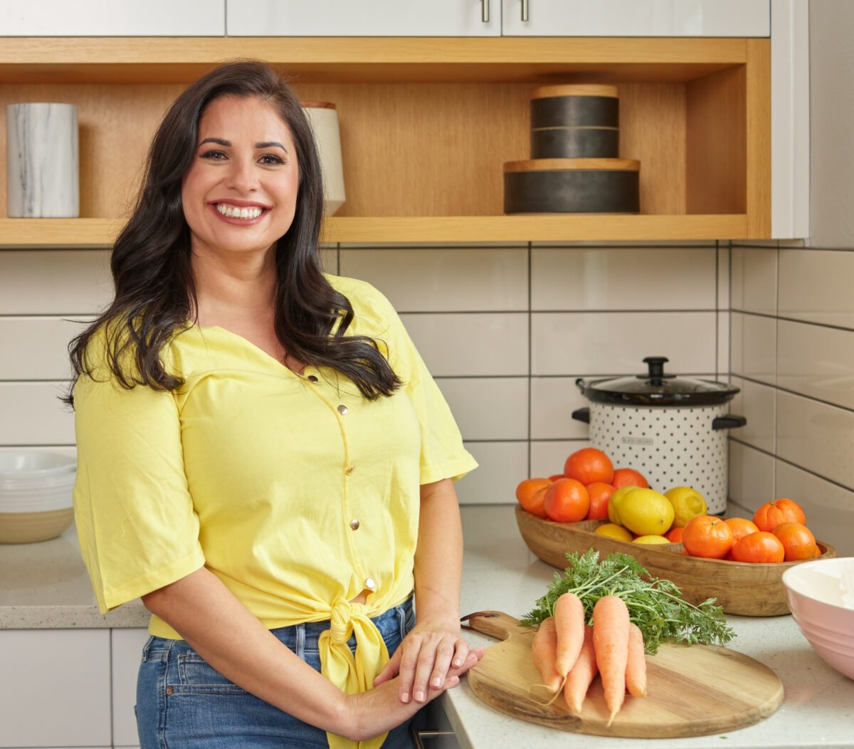 Sarah Olson in a yellow shirt and jeans.