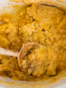 crockpot with peach cobbler with some dished out.