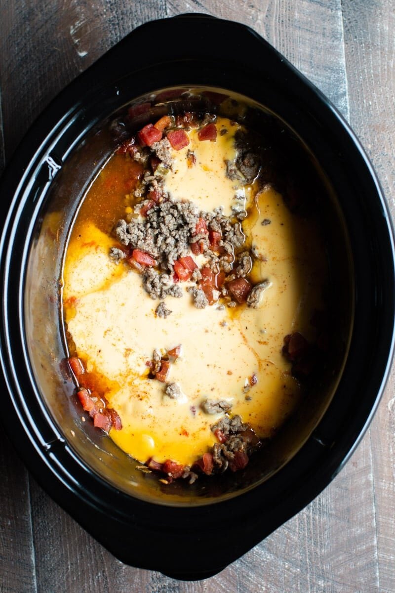melted velveeta in slow cooker with ground beef and rotel