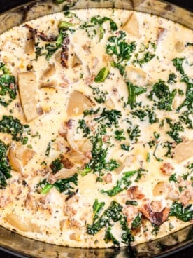 Close up of zuppa toscana in a black crockpot.