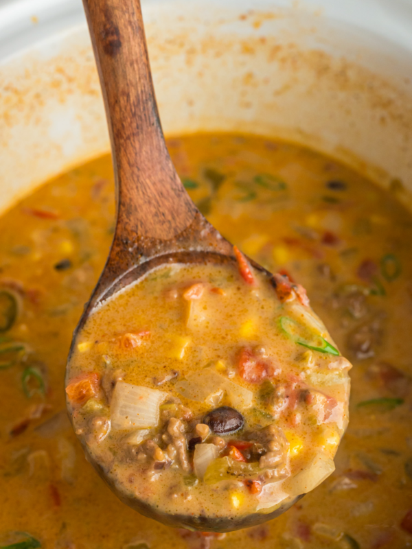 Nacho soup in a ladle.